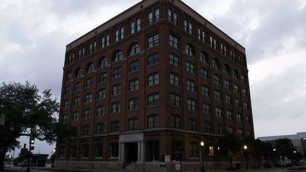 As A Car Passes The Camera Pans Up The Sixth Floor Museum