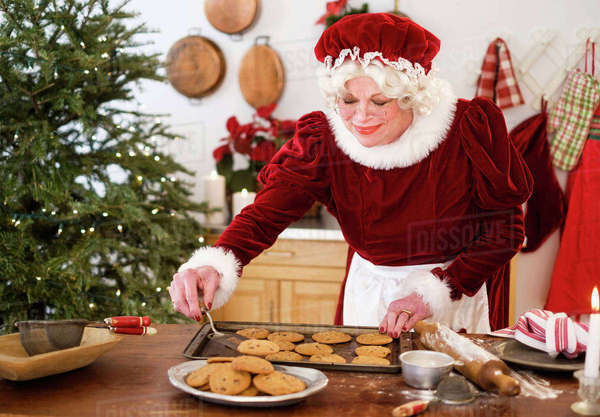 Mrs. Claus making gingerbread cookies - Stock Photo - Dissolve