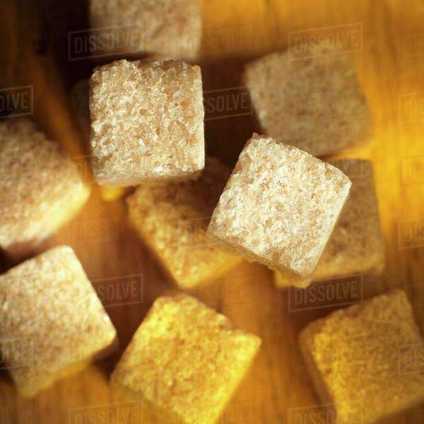 Several cane sugar cubes Stock Photo Dissolve