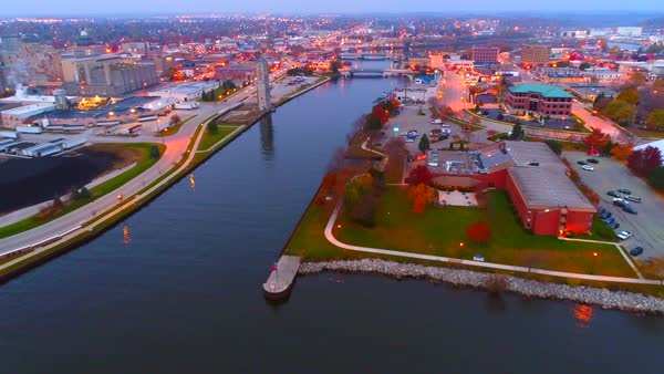 aerial view flying into manitowoc wisconsin at twilight along the manitowoc river stock footage manitowoc stock
