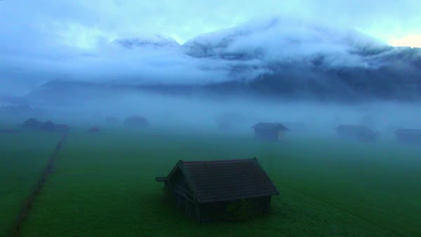 Ws Aerial Zo Log Cabins In Mountain Meadow In Fog Stock Video