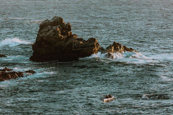 Friends kayaking in sea, Big Sur, California, United States - Stock