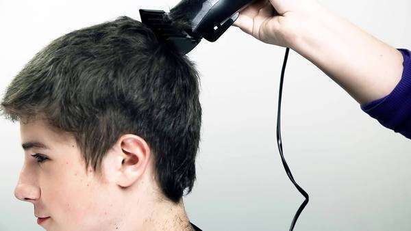 Young Man Visiting Hairdresser To Get A New Hair Cut Woman