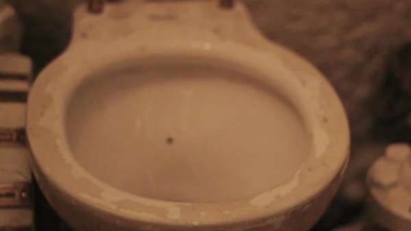Cylinder Pipes And Some Toilet Bowl In A Tiled Comfort Room With