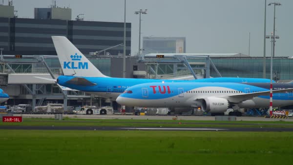 AMSTERDAM, THE NETHERLANDS - JULY 27, 2017: Boeing 737 KLM PH-BXL and TUIfly Boeing 787 Dreamliner taxiing before departure, Boeing 777 KLM PH-BVK