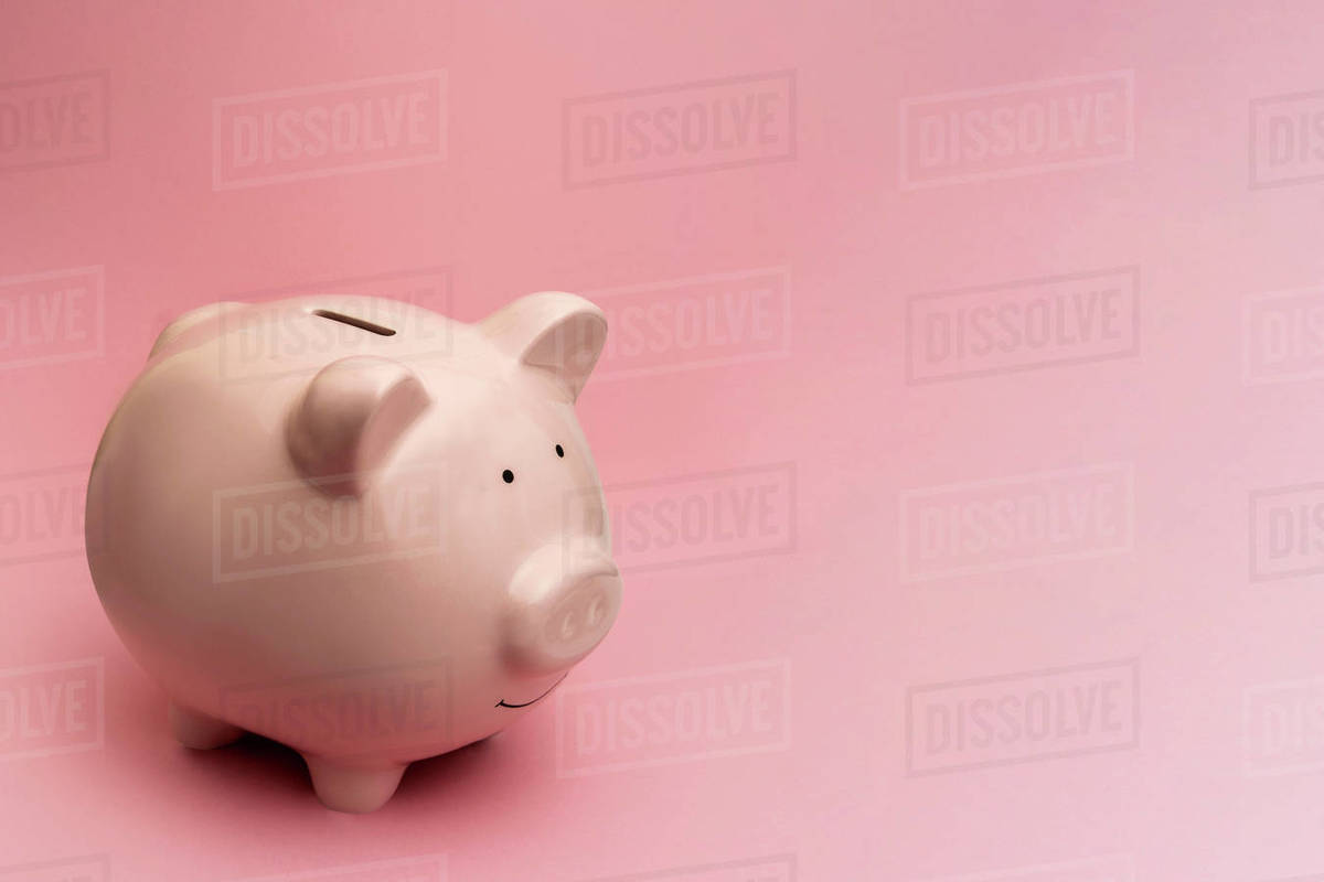 Piggy bank on pink background - Stock Photo - Dissolve
