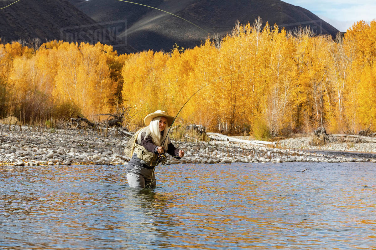 USA, Idaho, Bellevue, Senior woman flyfishing in Big Wood River in