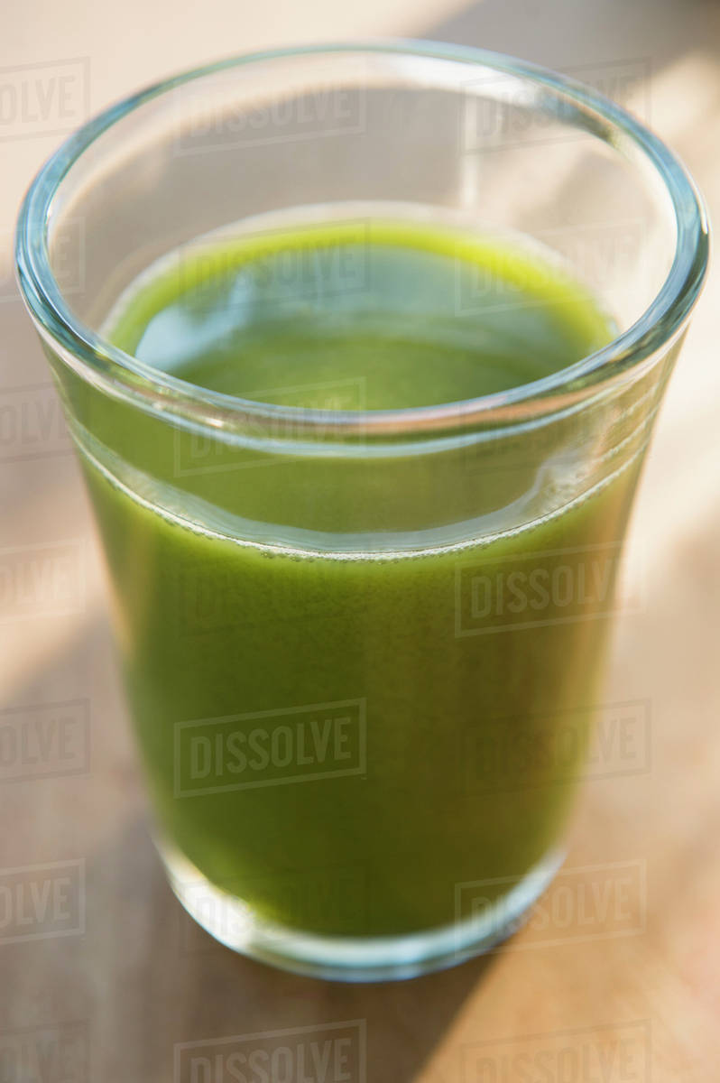 Glass of green juice Stock Photo Dissolve