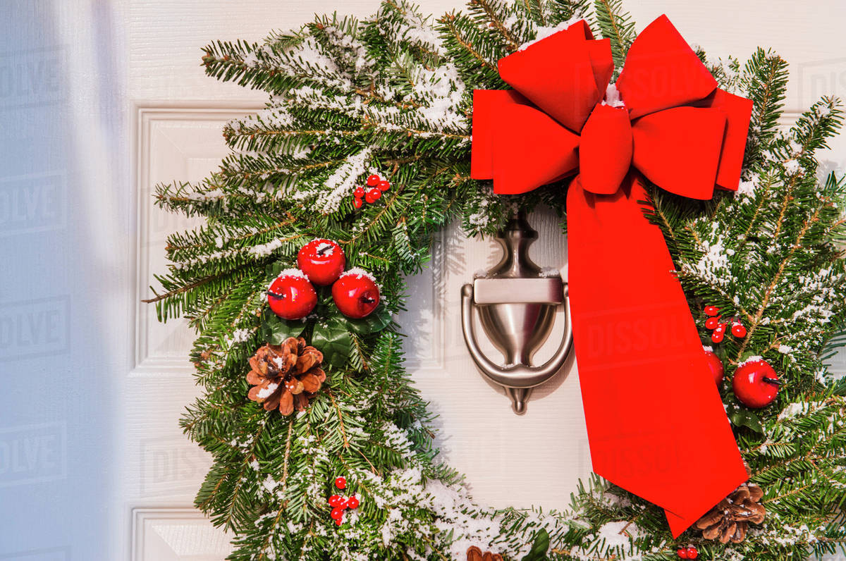 Christmas wreath hanging on door Stock Photo Dissolve