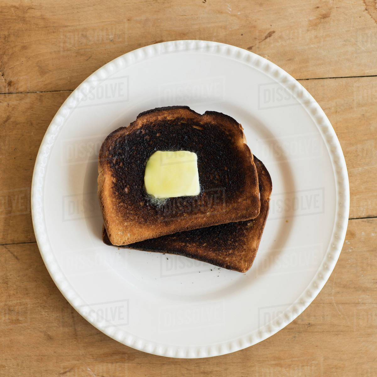 Burnt toasts on plate Stock Photo Dissolve