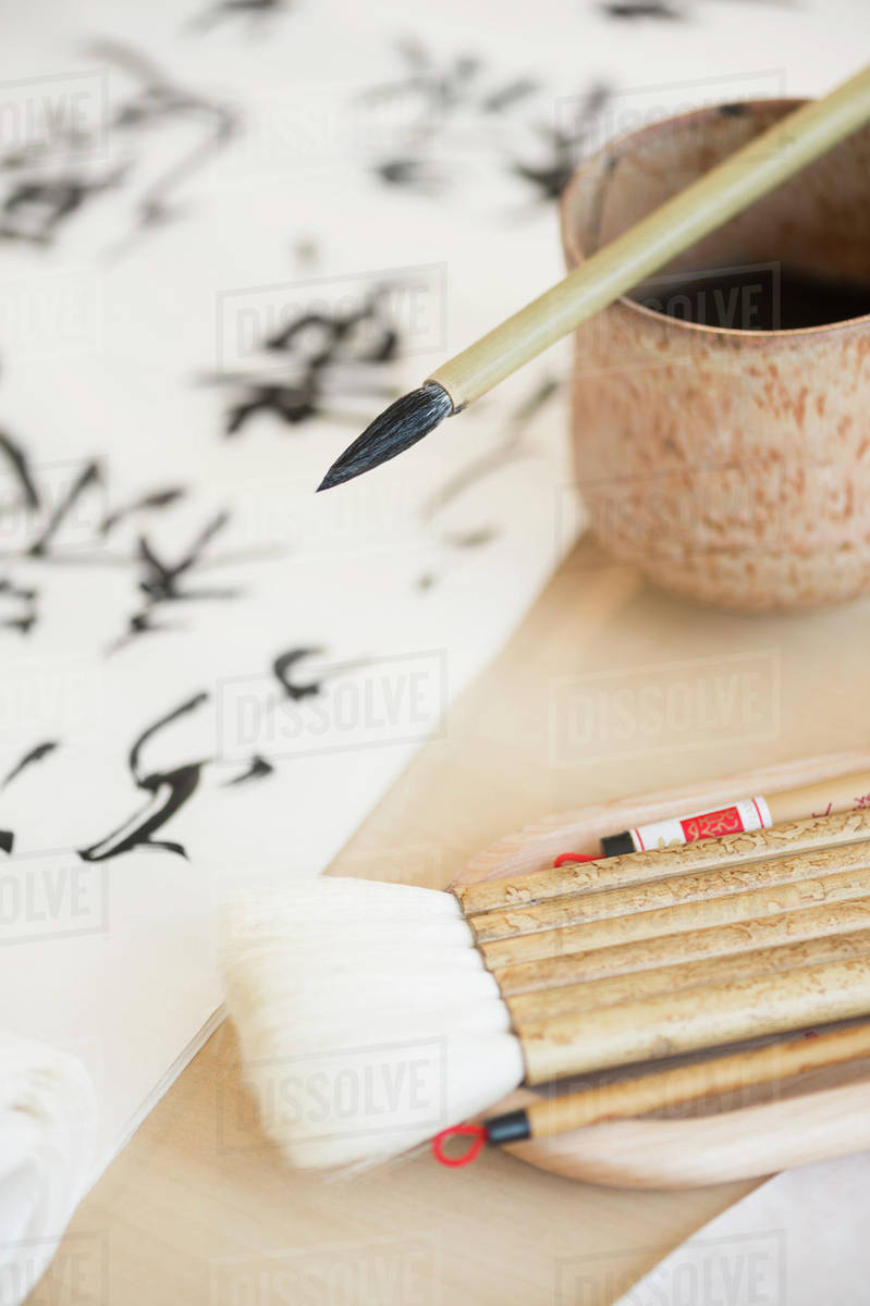 Calligraphy paintbrushes, ink and Japanese script Stock Photo Dissolve