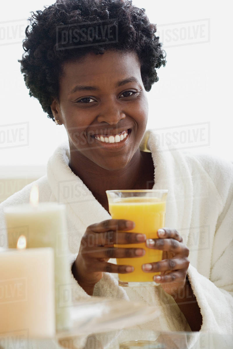 Woman drinking juice in spa Stock Photo Dissolve