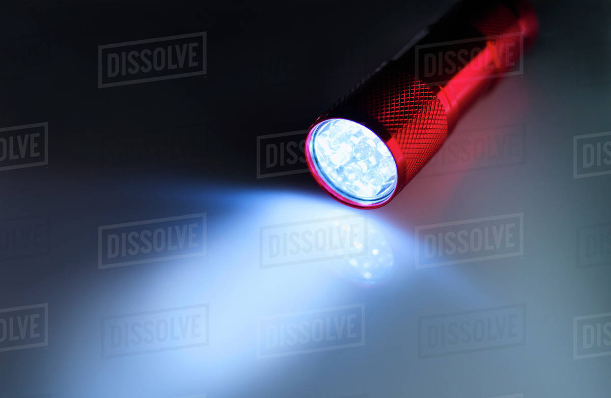 Illuminated flashlight Stock Photo Dissolve