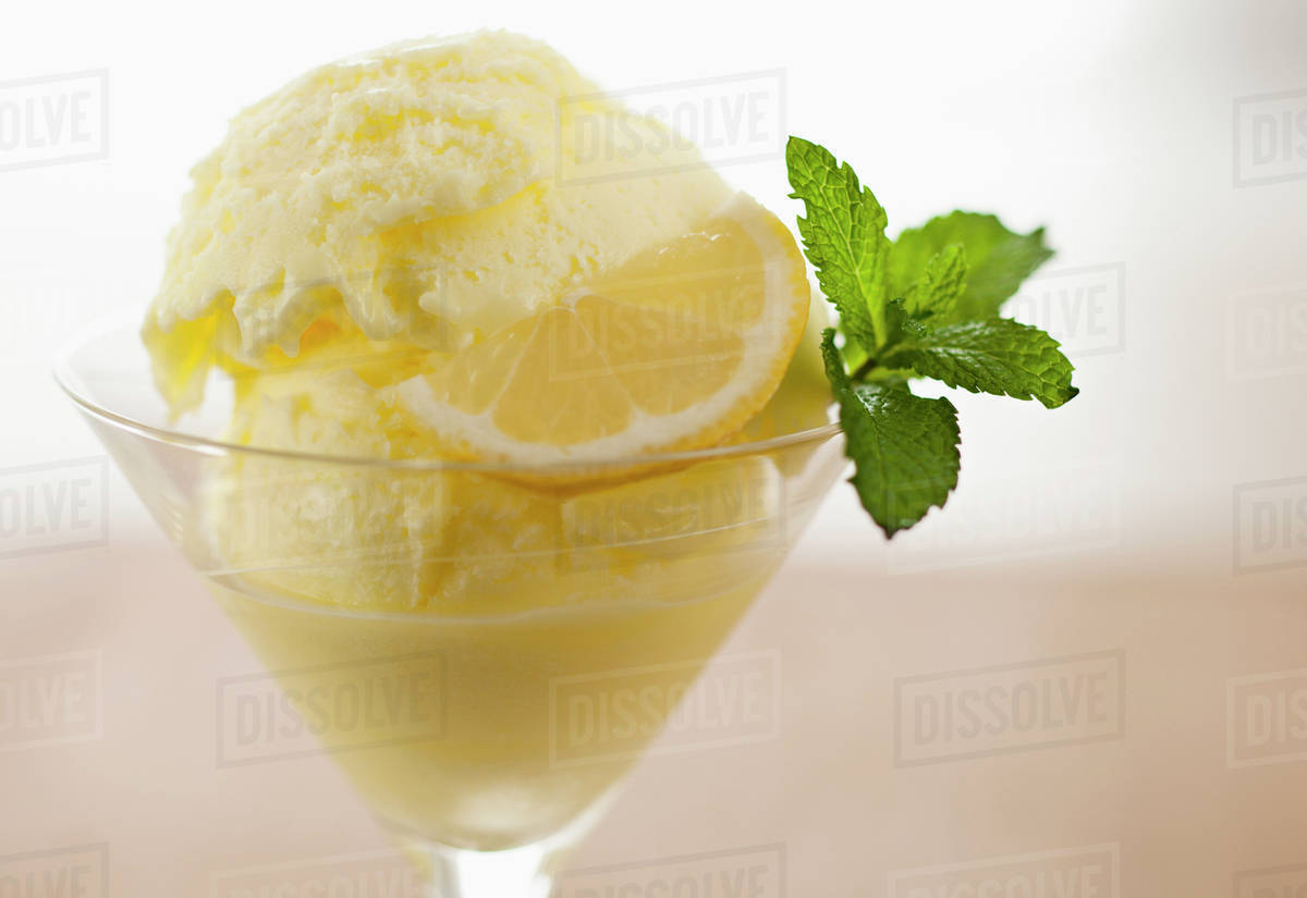 Close up of ice cream with mint leaf and lemon slice Stock Photo