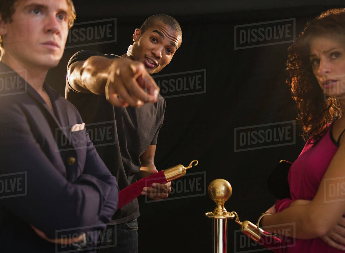 Bouncer pointing outside club Stock Photo Dissolve