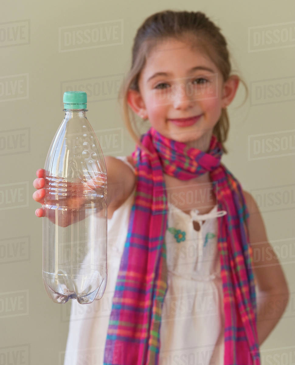 Young girl holding a plastic water bottle Stock Photo Dissolve