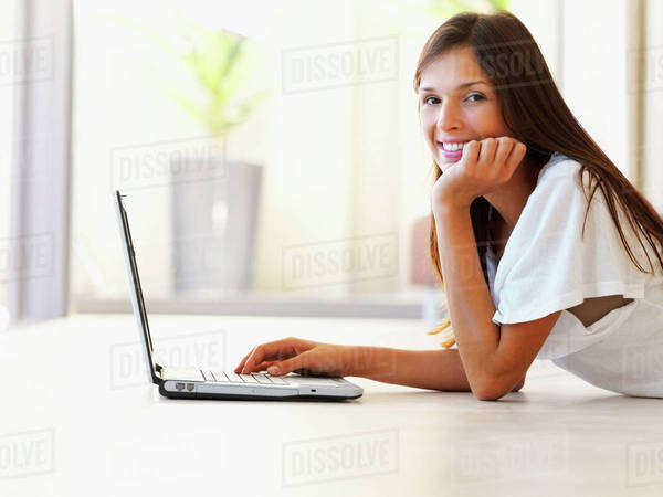 Woman typing on laptop - Royalty-free Stock Photo | Dissolve