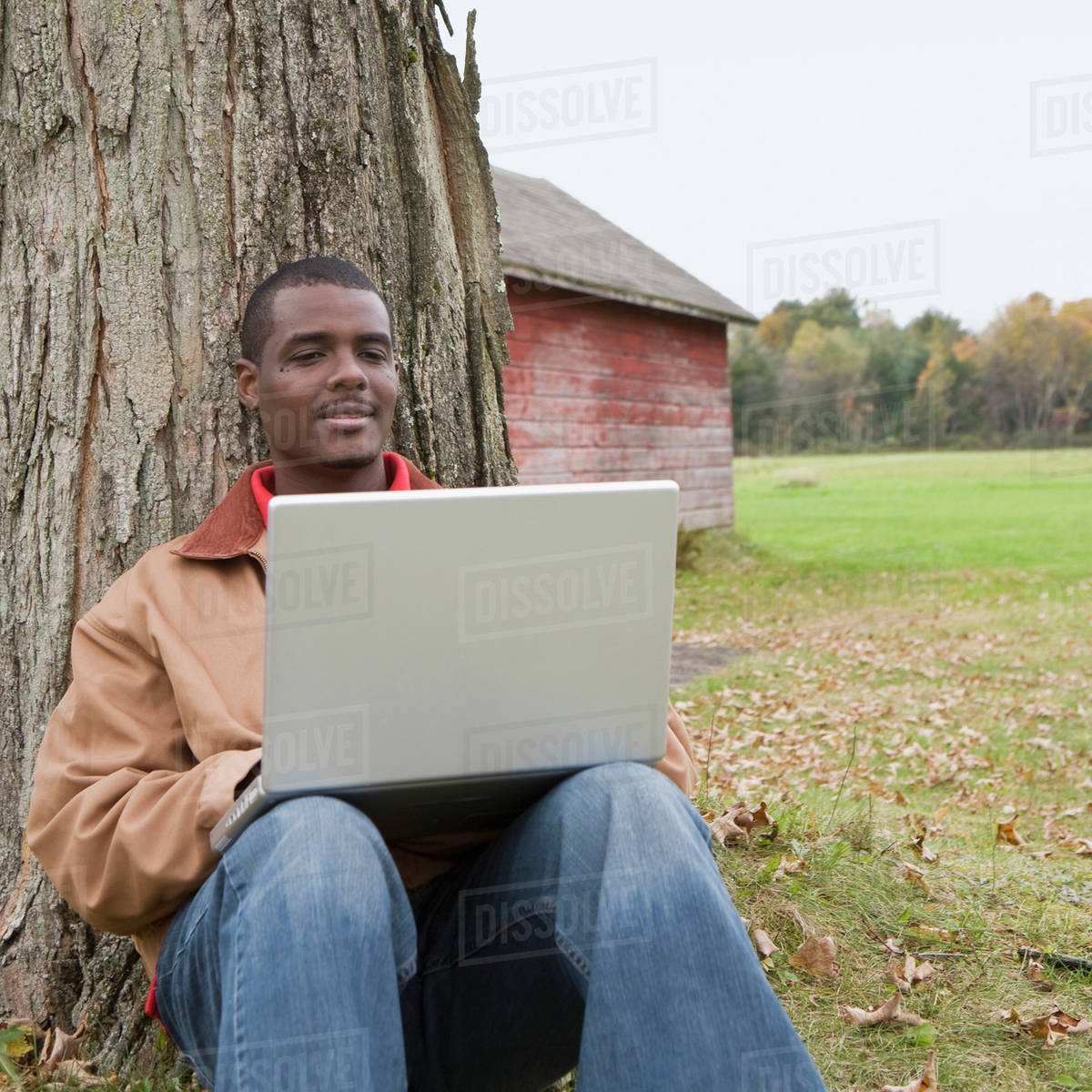 Man using laptop outside Stock Photo Dissolve