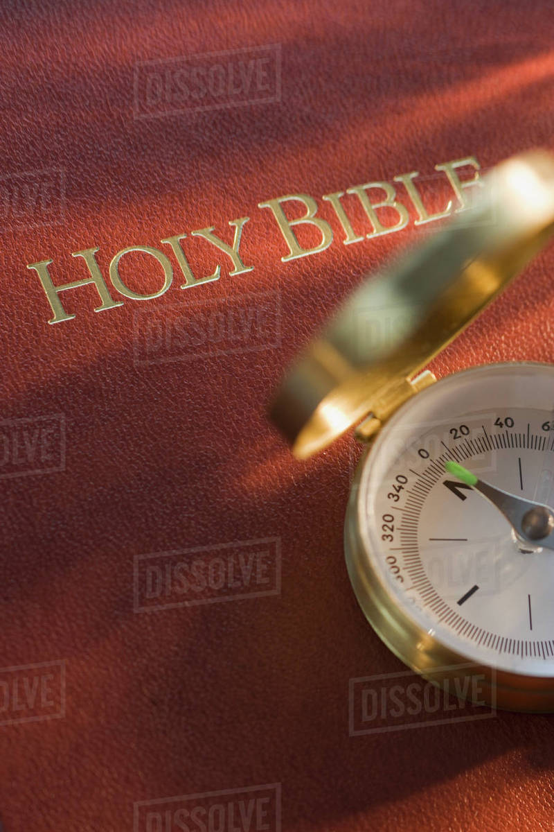 Compass and Holy Bible Stock Photo Dissolve