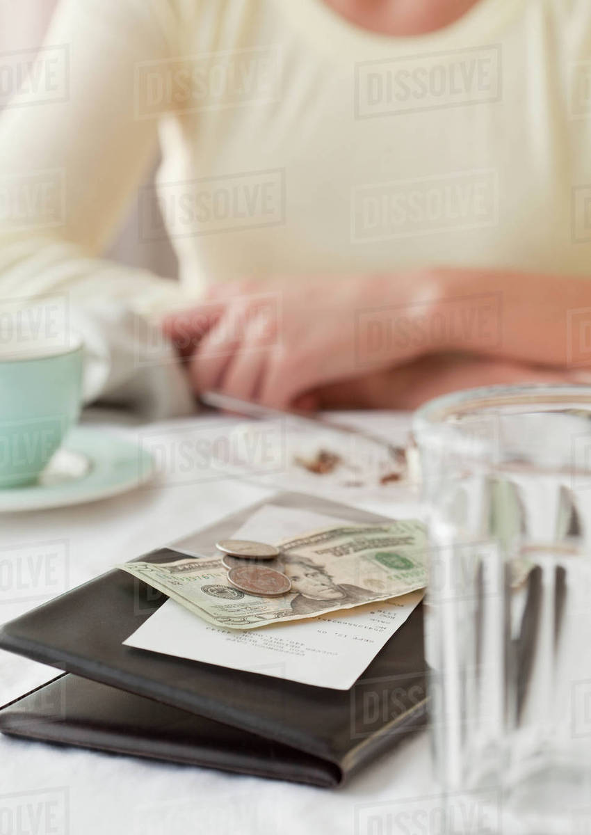 Woman paying restaurant bill Stock Photo Dissolve