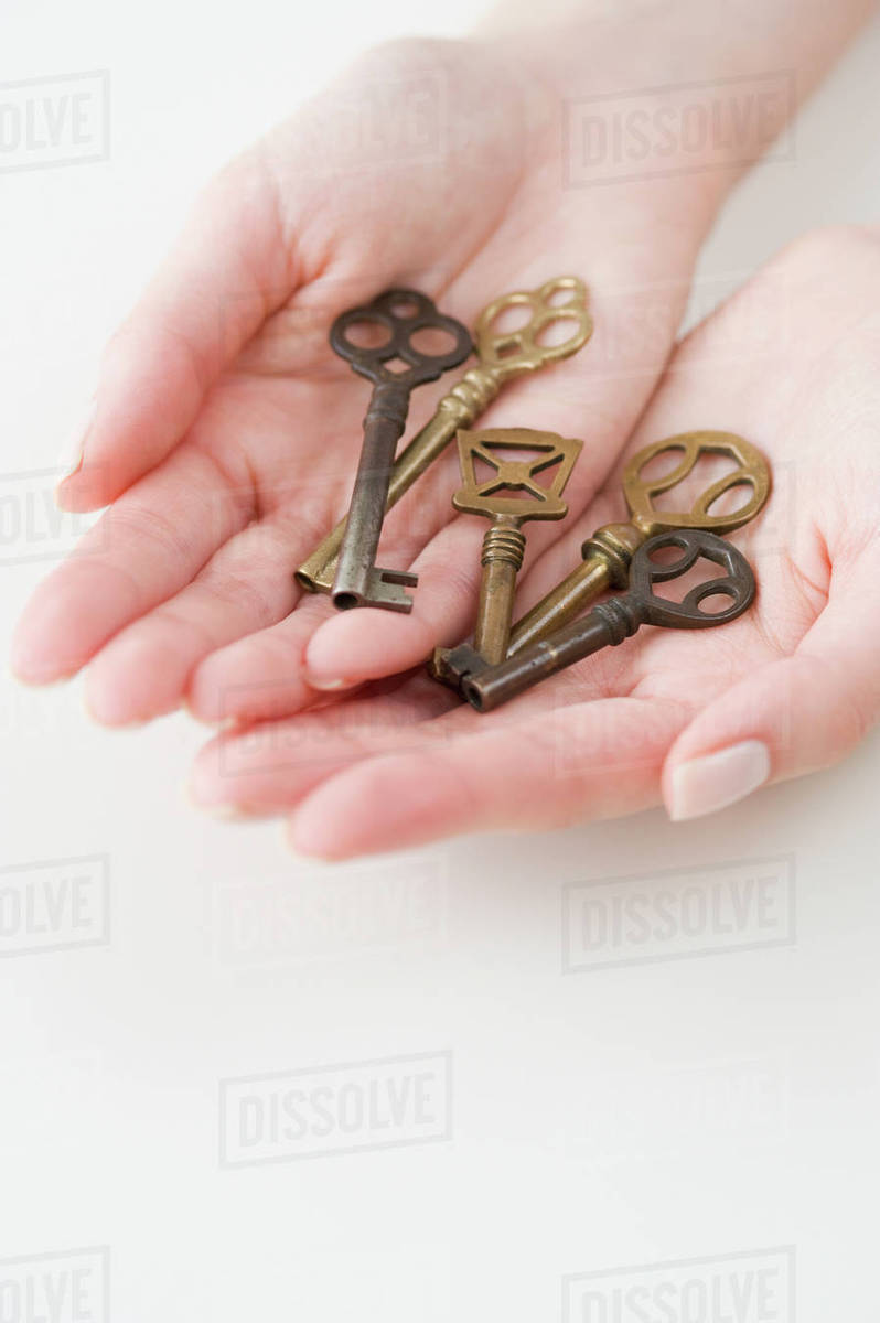 Old fashioned keys in woman’s hands Stock Photo Dissolve