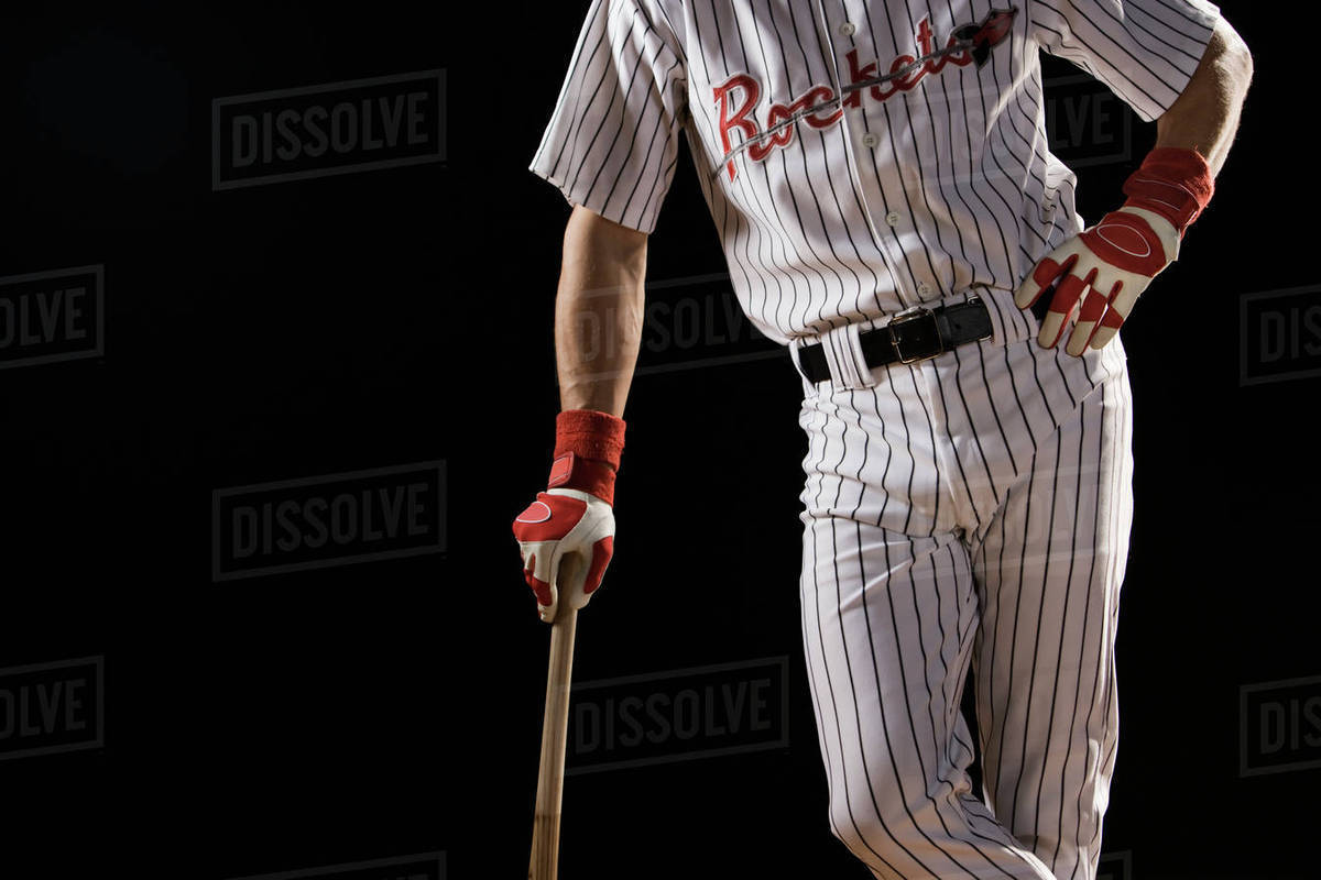 Midsection portrait of baseball player leaning on bat Stock Photo