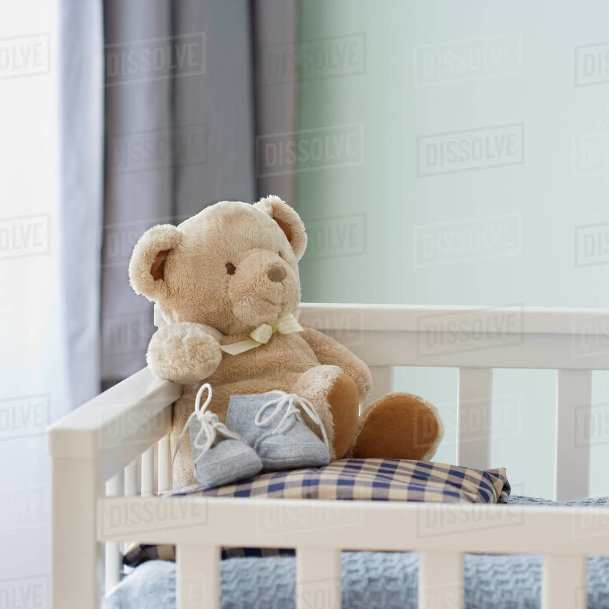 Teddy bear in crib Stock Photo Dissolve