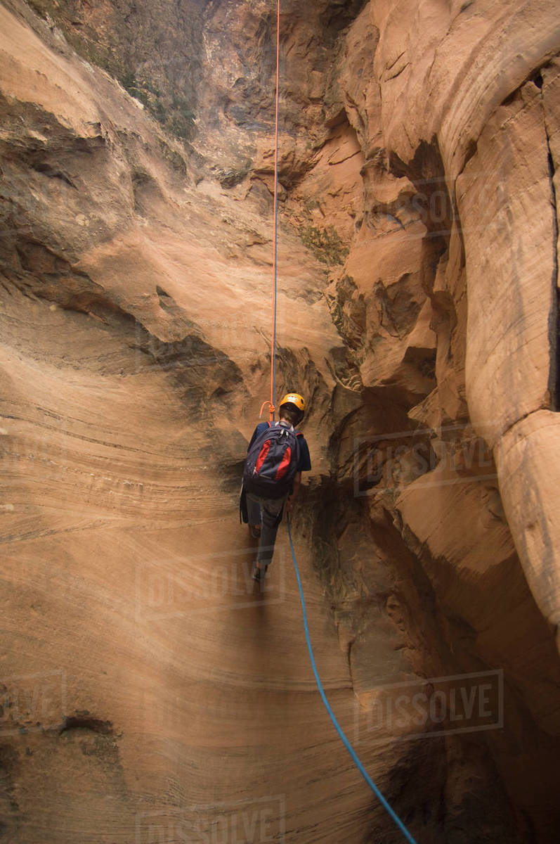 Person canyon rappelling Stock Photo Dissolve