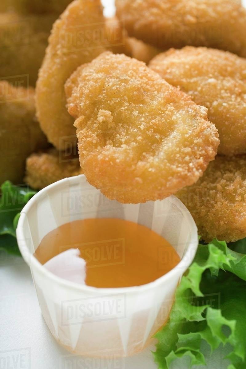 Chicken Nuggets with sweet and sour sauce Stock Photo Dissolve