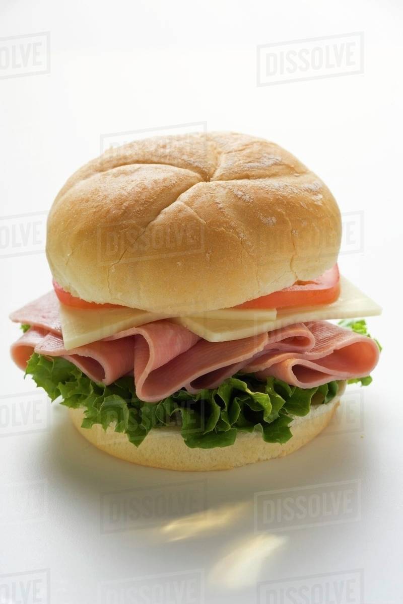 Ham, cheese and tomato in kaiser roll Stock Photo Dissolve