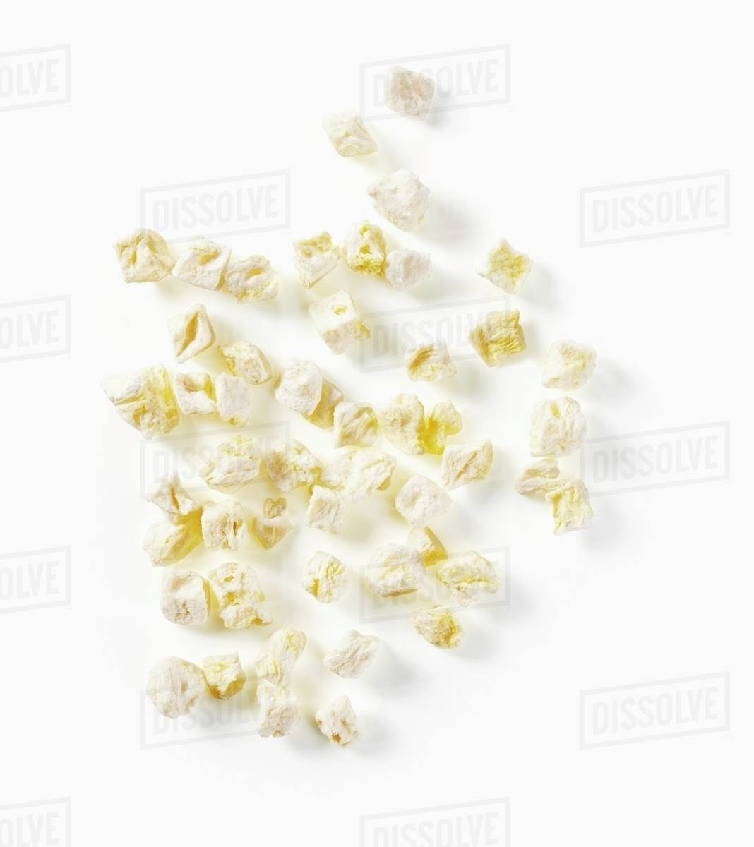 Dried pineapple pieces, seen from above Stock Photo Dissolve