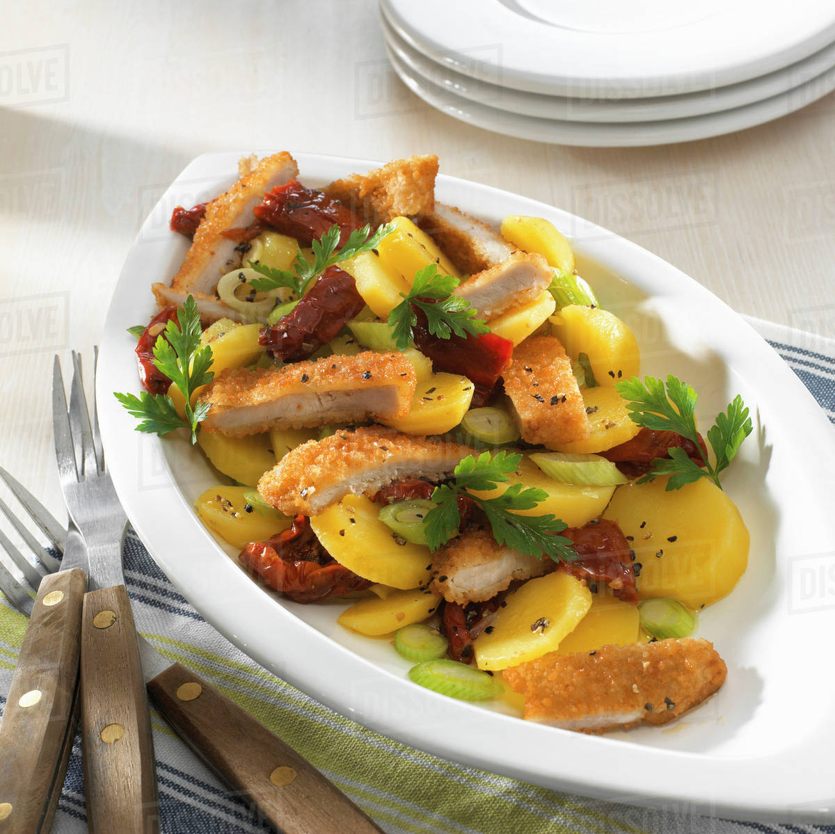 Chicken escalope, breaded and cut into pieces Stock Photo Dissolve