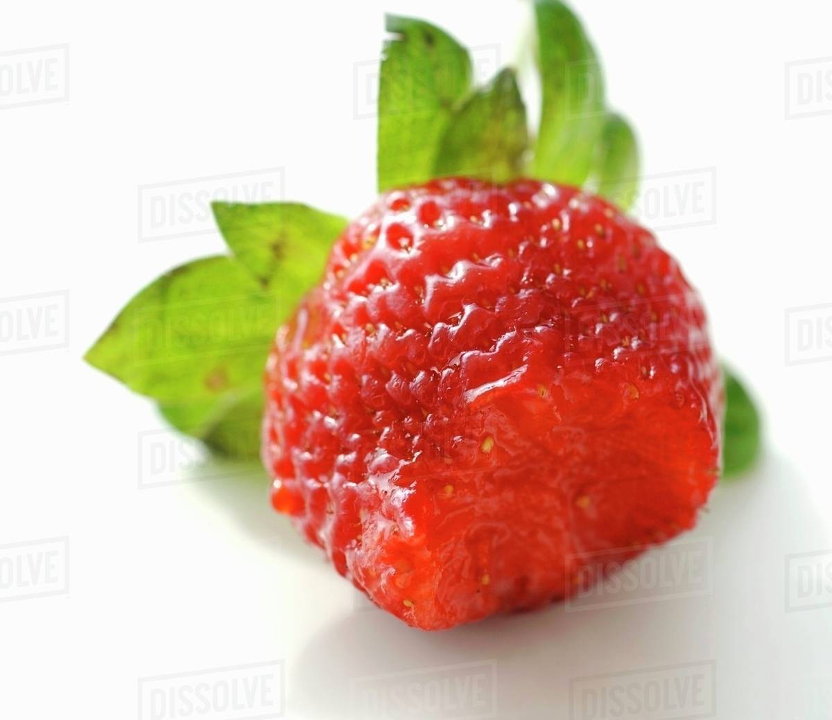 A strawberry with a bite taken Stock Photo Dissolve