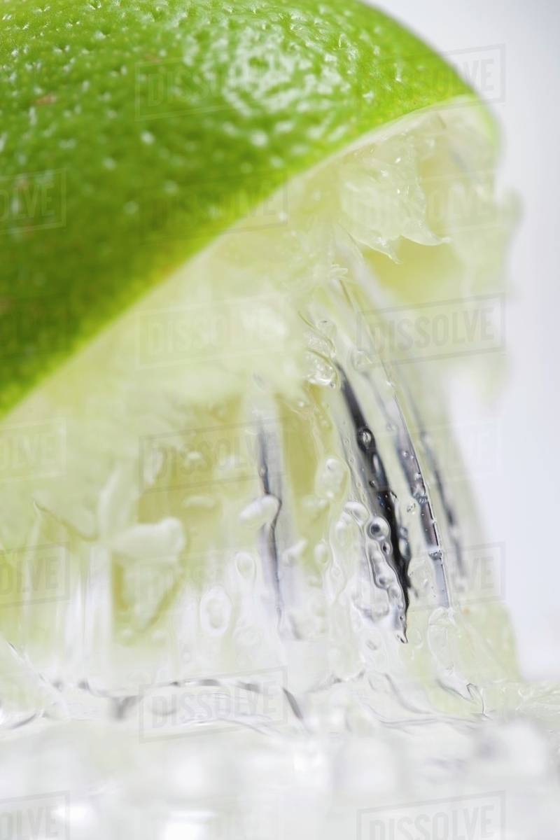 A lime being juiced (closeup) Stock Photo Dissolve