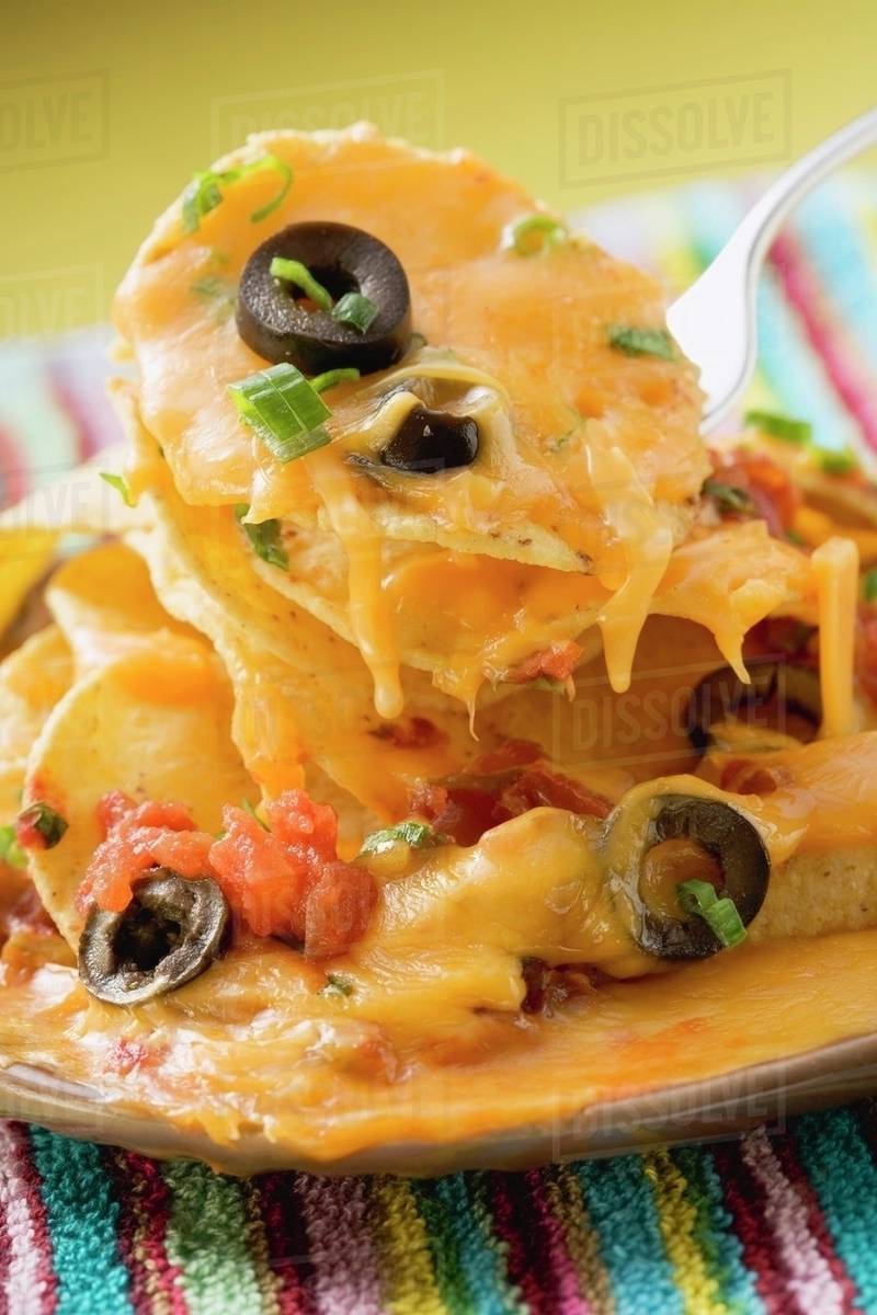 Tortilla chips with melted cheese on plate & fork (Mexico) Stock