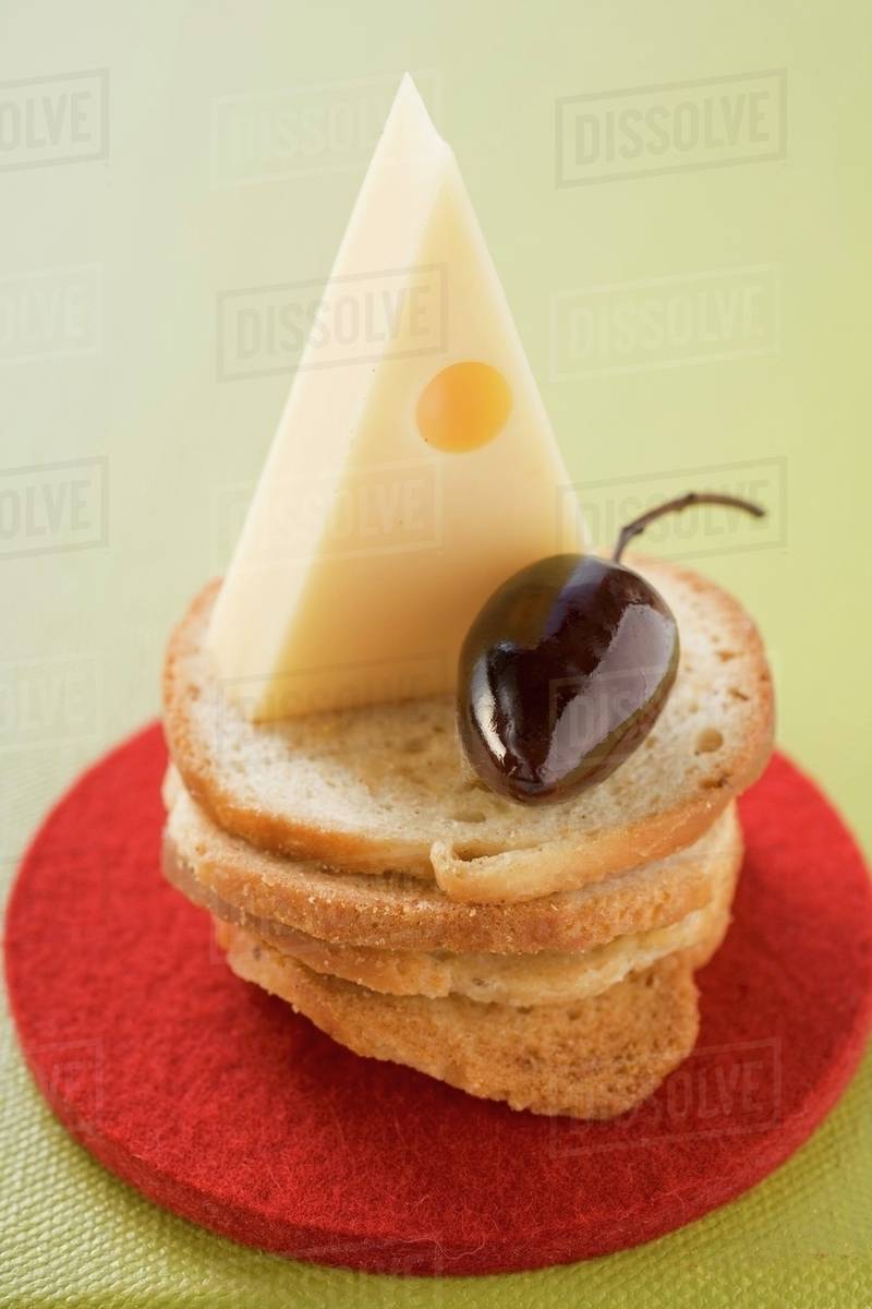 Emmental cheese and olive on slices of white bread Stock Photo Dissolve