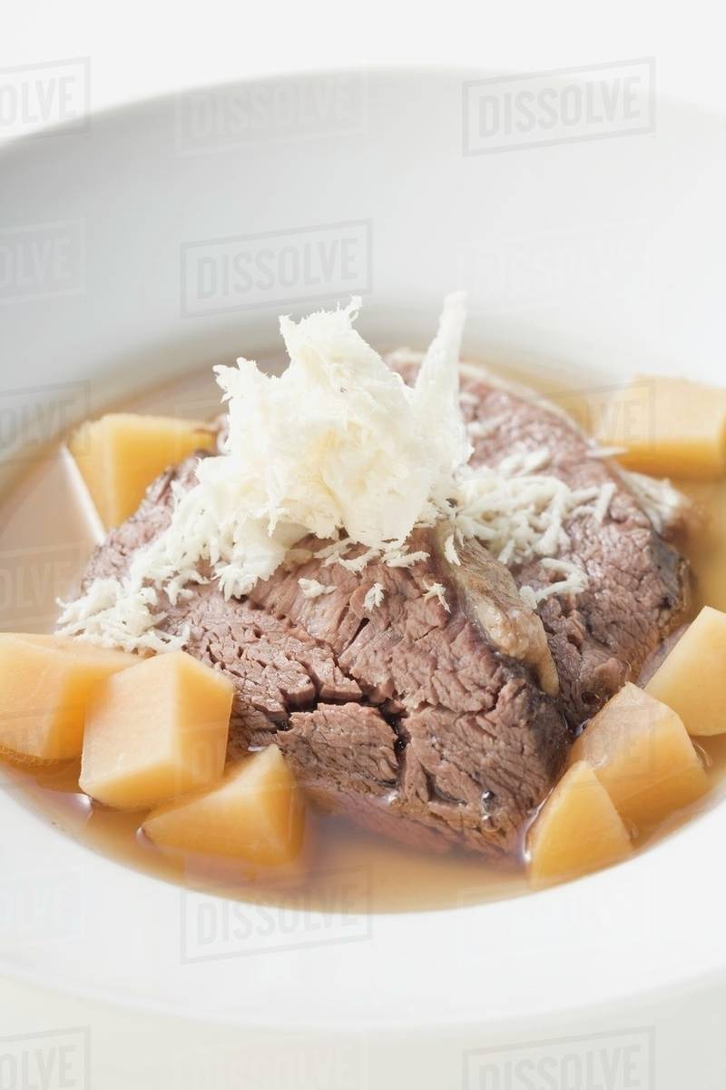 Boiled beef with horseradish in broth Stock Photo Dissolve
