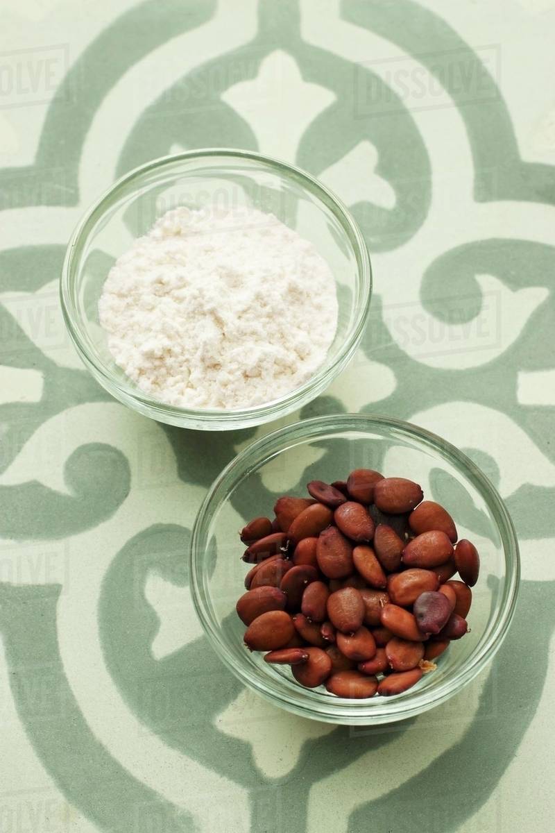 Carob bean flour and carob bean seeds Stock Photo Dissolve