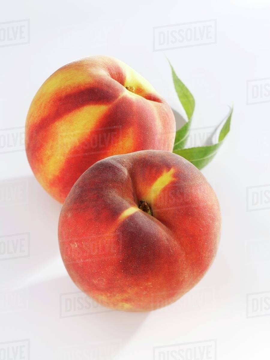 Two whole peaches Stock Photo Dissolve