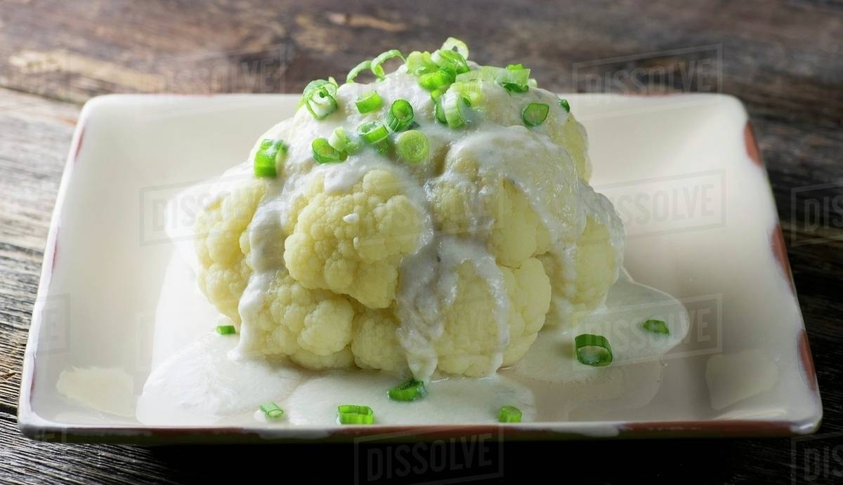 Cauliflower with a white sauce Stock Photo Dissolve
