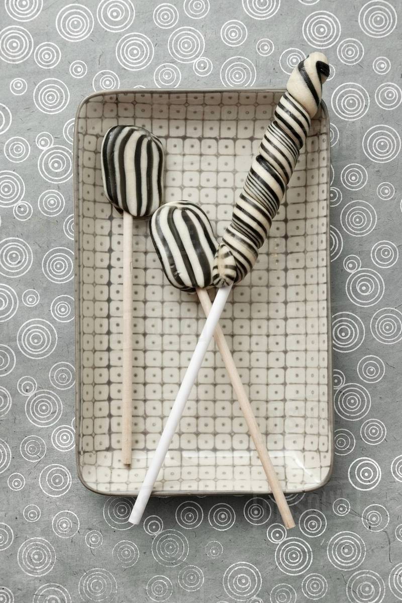 Three liquorice lollies (seen from above) Stock Photo Dissolve