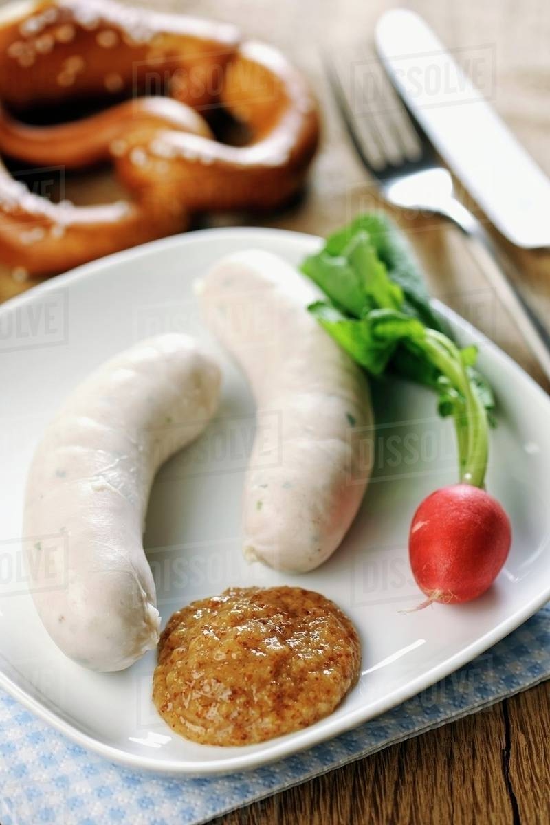 Veal sausages with sweet mustard, radishes and a pretzel (Bavaria
