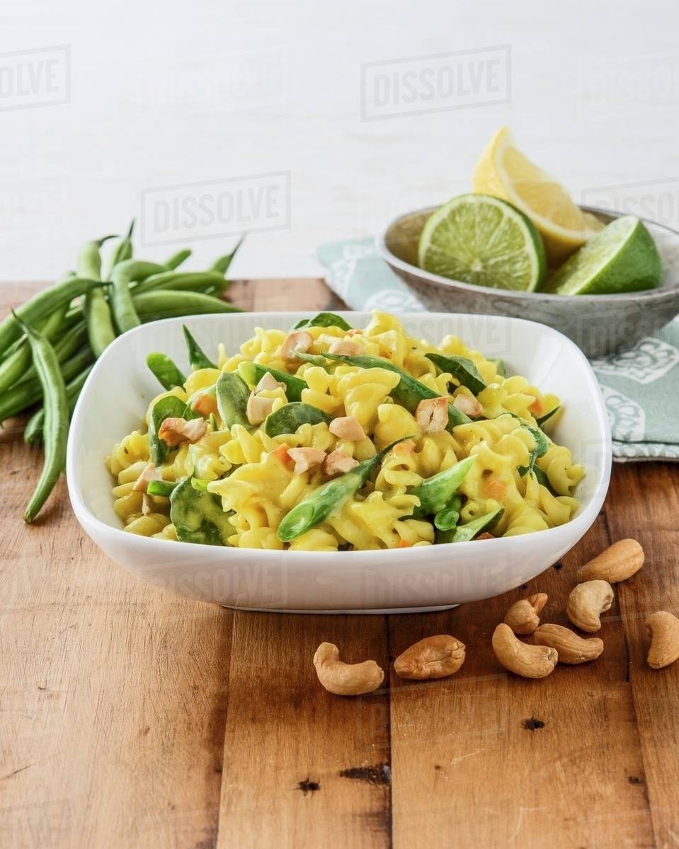 Fusilli with green beans, baby spinach and cashew nuts Stock Photo