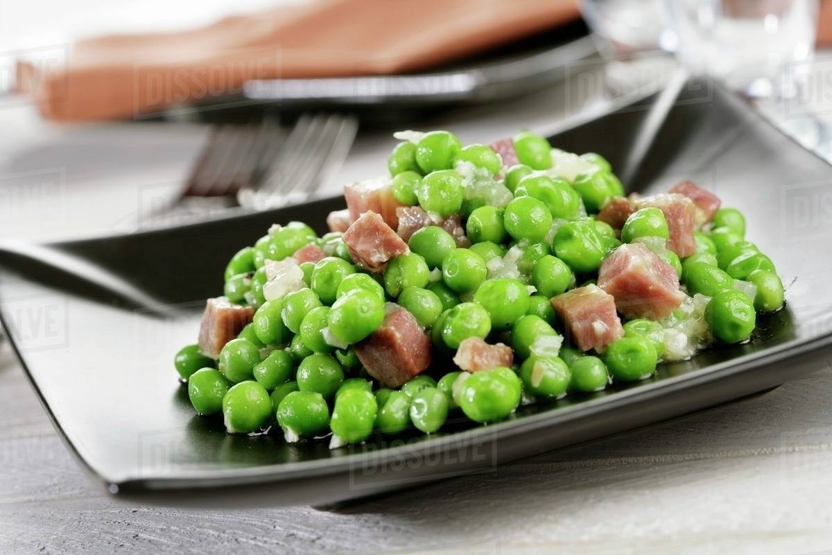 Peas with smoked ham (Spain) Stock Photo Dissolve