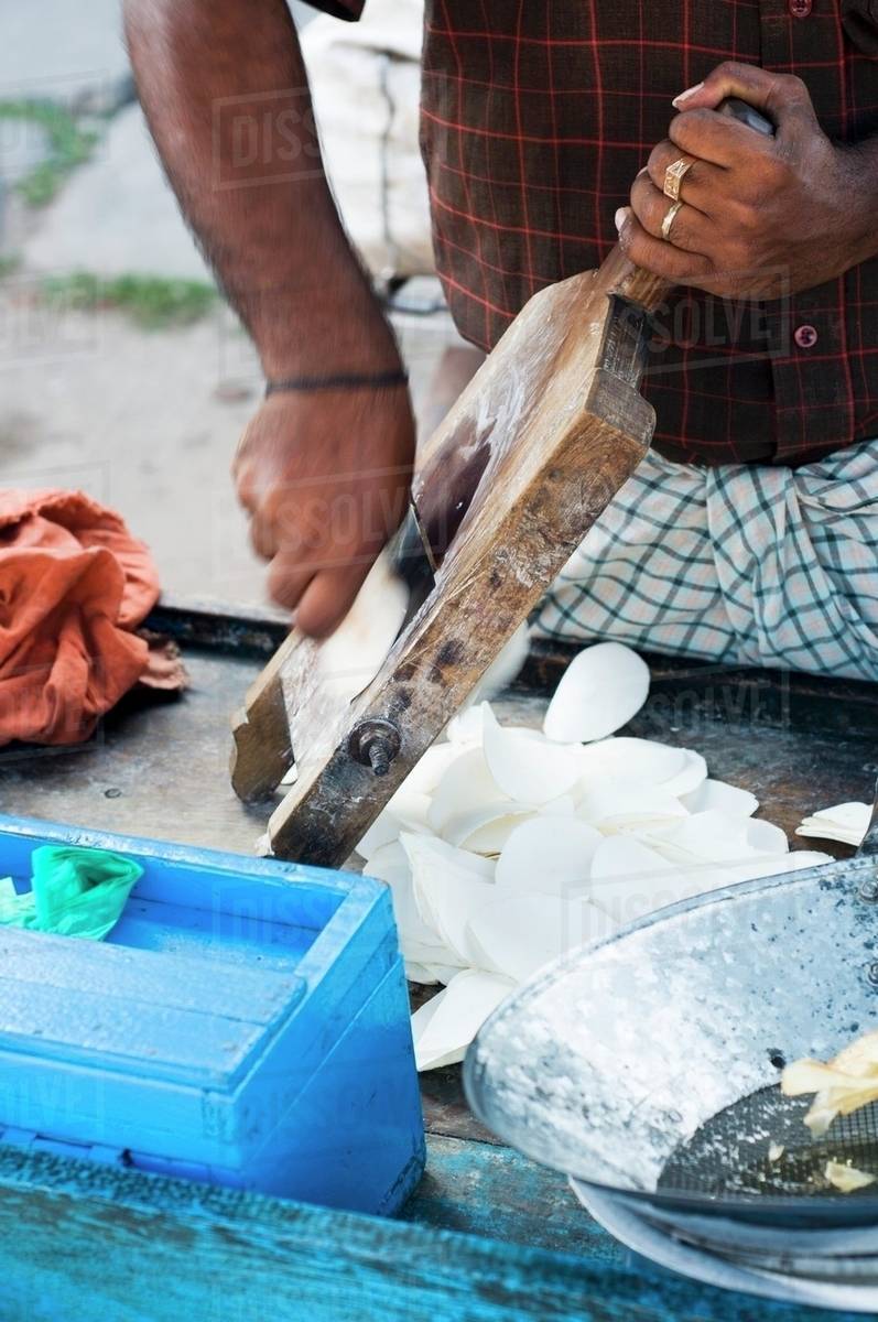 An Indian street vendor preparing potato chips Stock Photo Dissolve
