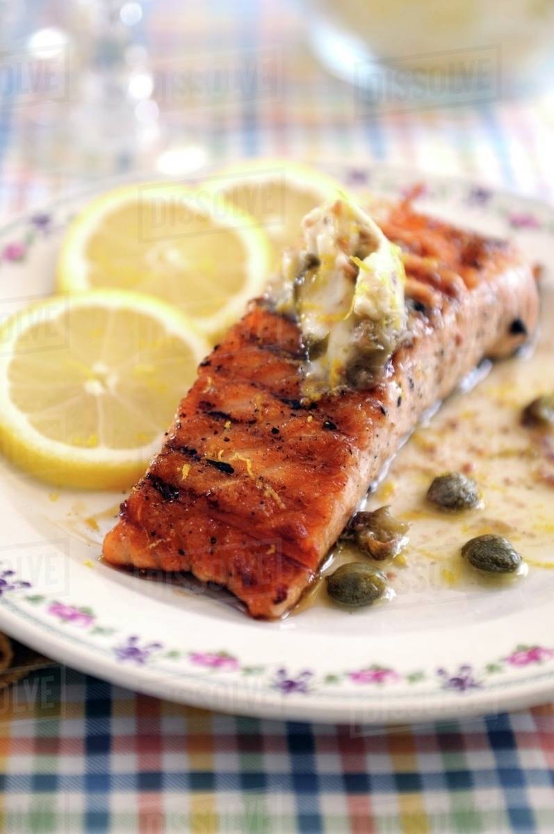 Fried salmon fillet with anchovies and caper butter Stock Photo