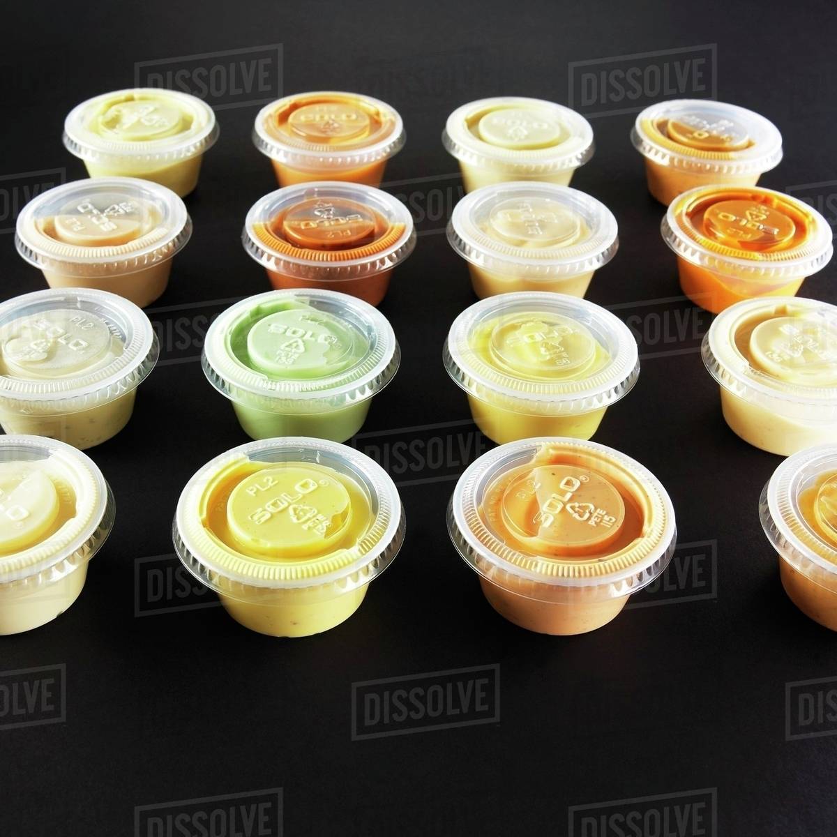 Various dips in small plastic bowls Stock Photo Dissolve