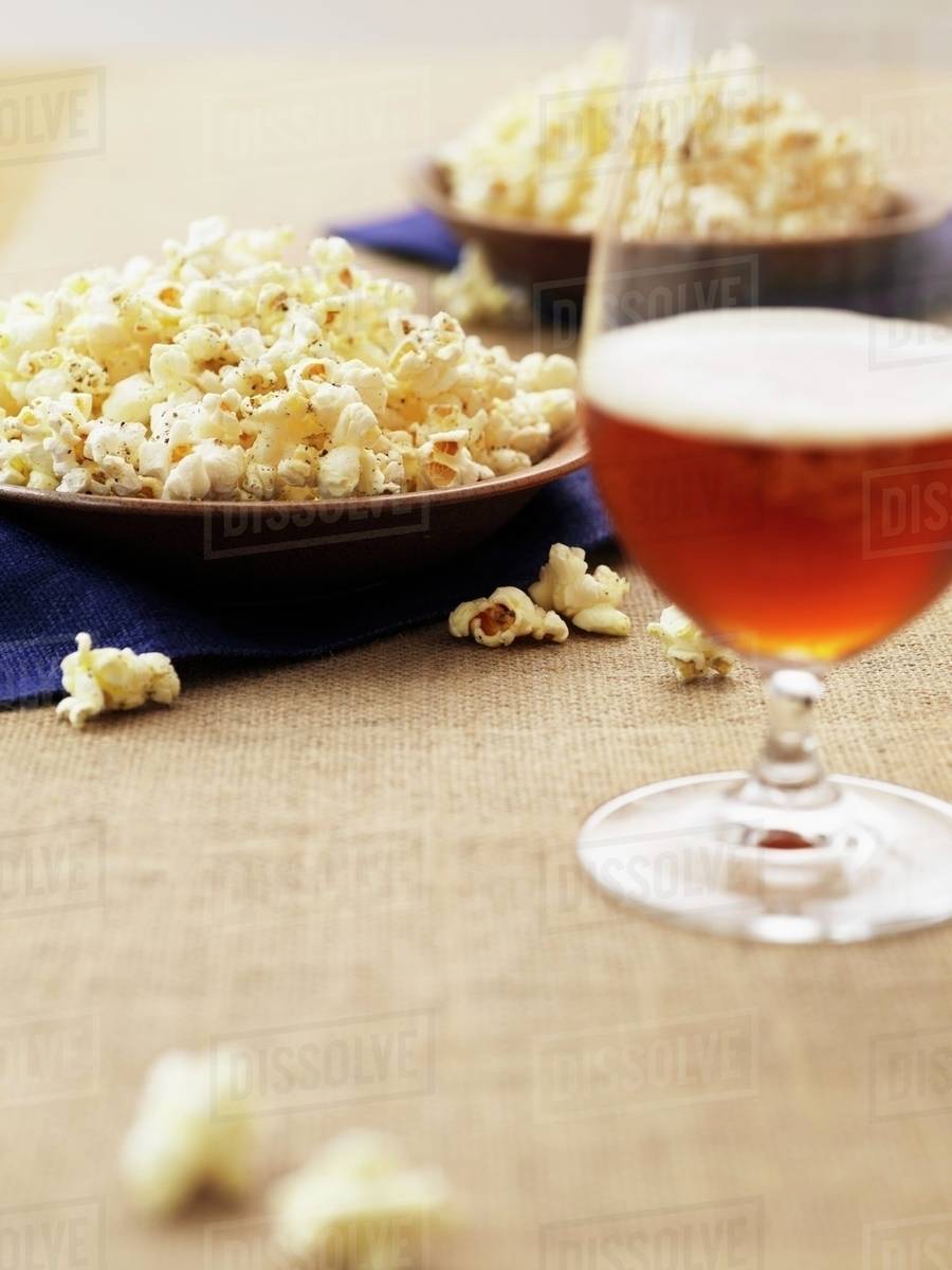 Popcorn and dark beer - Stock Photo - Dissolve