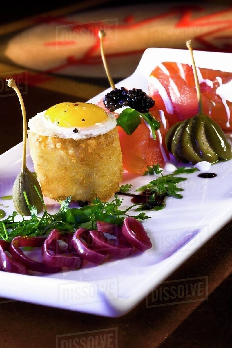 Salmon with a Quail Egg, Roe, Caper Berries and Balsamic Dressing Stock Photo Dissolve
