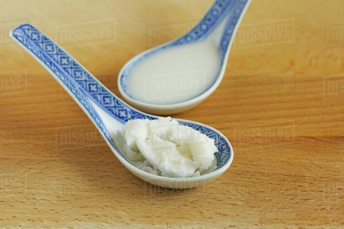 Coconut fat, solid and liquid Stock Photo Dissolve